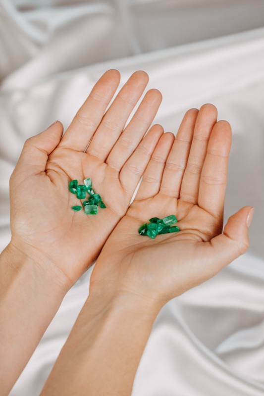 Colombian emeralds held in hand, selected for a bespoke piece